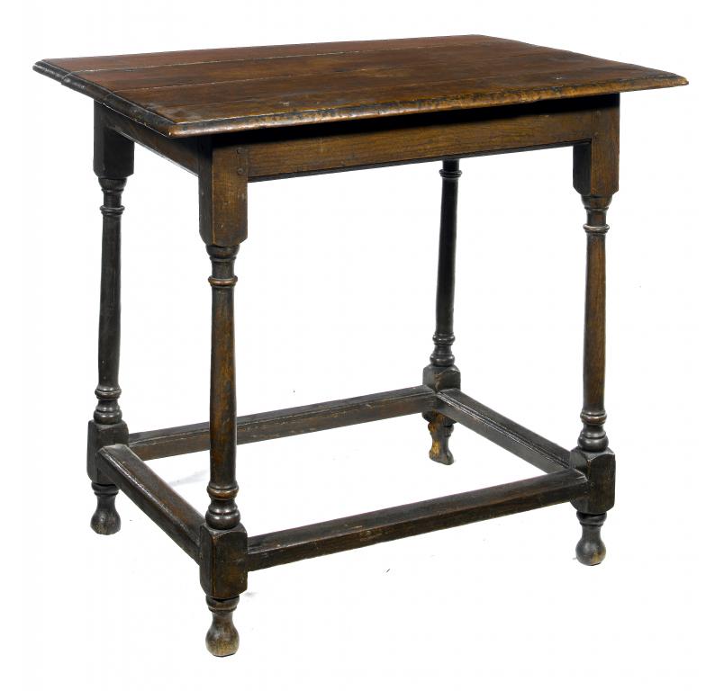 Appraisal: A GEORGE II OAK SIDE TABLE the oversailing boarded top