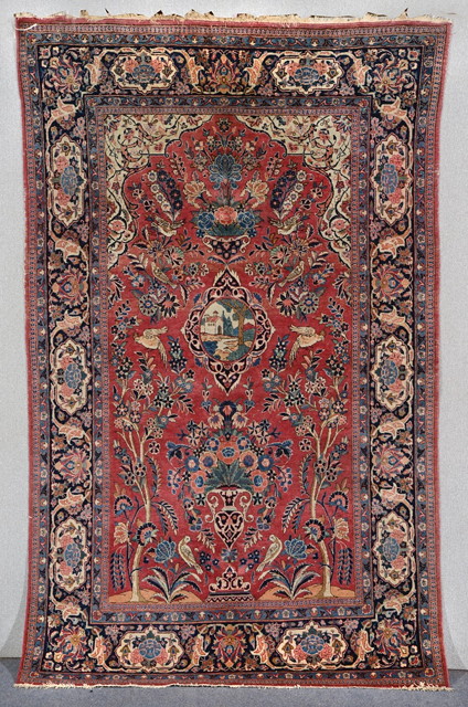 Appraisal: A PERSIAN KASHAN RED GROUND PICTORIAL RUG decorated a central