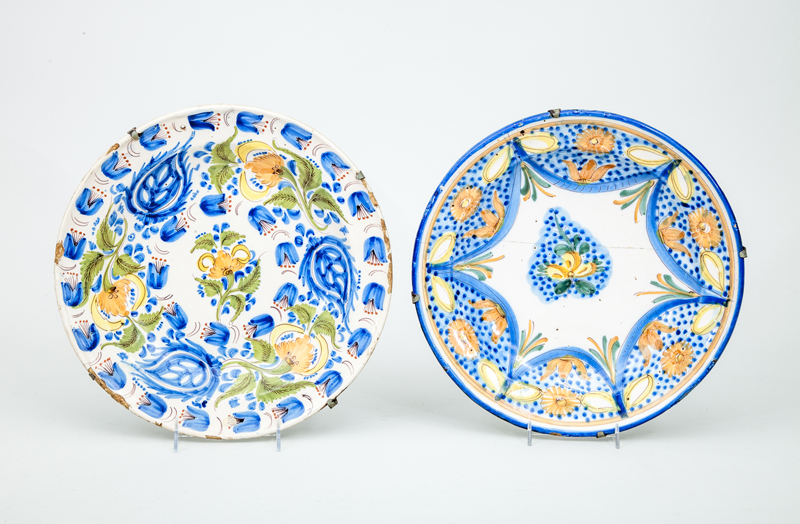 Appraisal: TWO POLYCHROME TIN-GLAZED EARTHENWARE CHARGERS The one staple repaired each