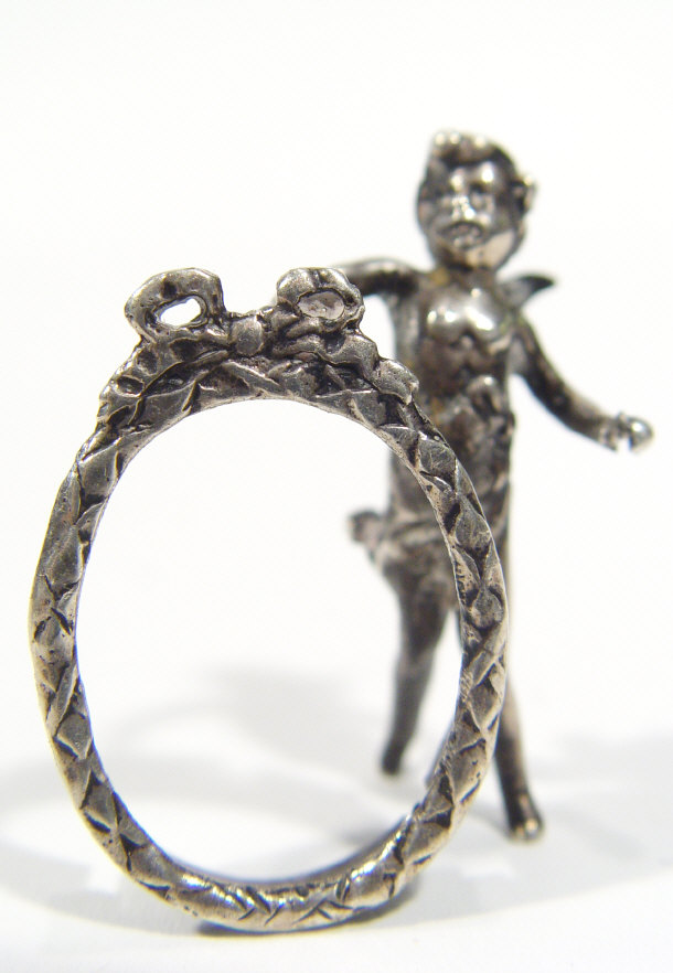 Appraisal: Continental grade miniature silver photo frame modelled as a cherub