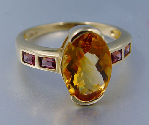 Appraisal: K CITRINE GARNET RING K yellow gold ring contains oval