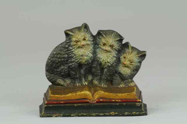 Appraisal: a B H THREE KITTENS ON BOOK DOORSTOP Bradley Hubbard