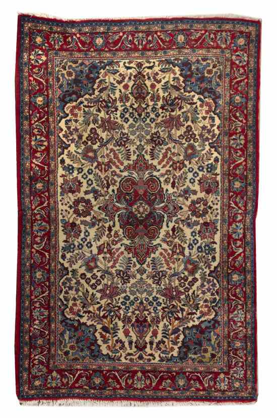 Appraisal: A Kirman Wool Rug having allover foliate and floral decoration