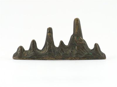 Appraisal: A Chinese bronze brushrest formed as a range of mountains