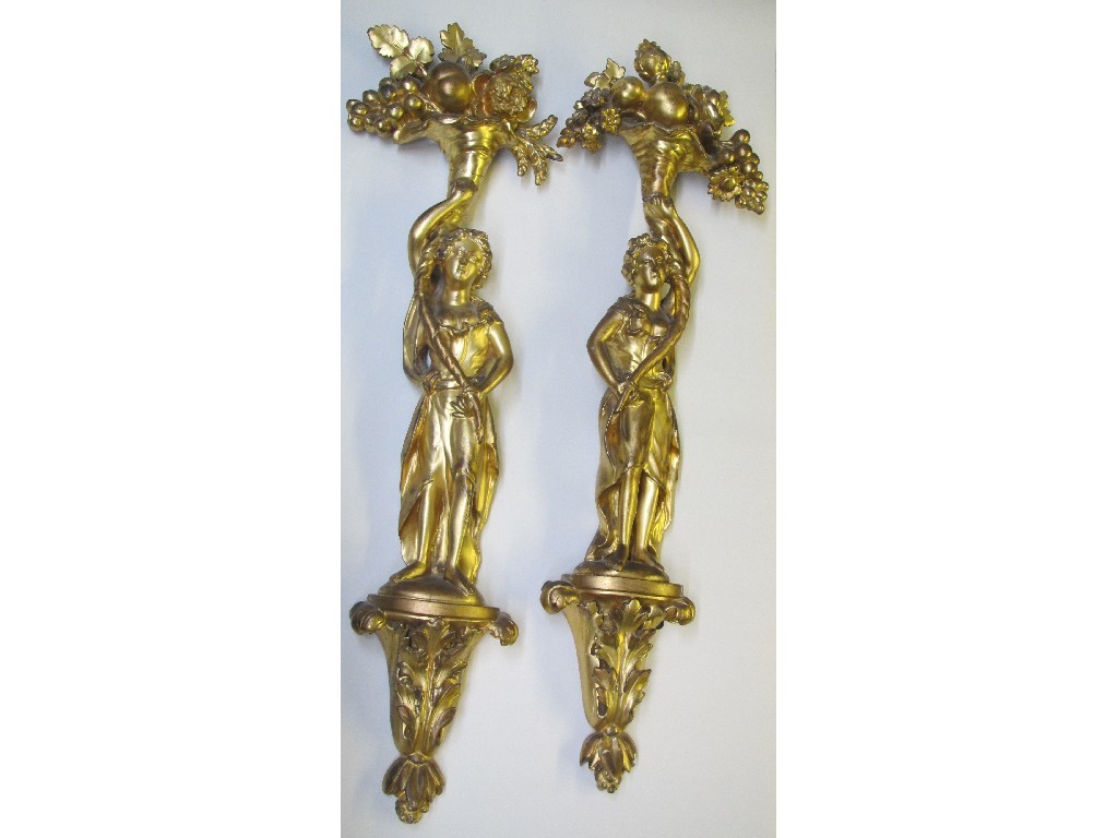 Appraisal: A pair of gilt wood appliques carved with female figures