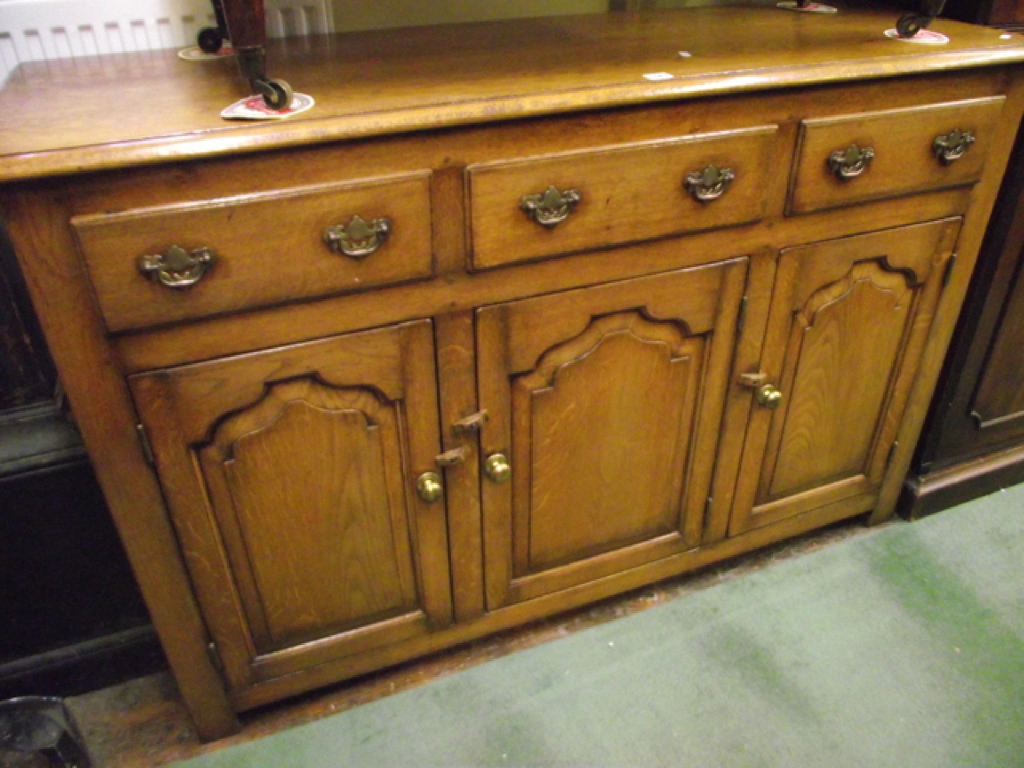 Appraisal: A Georgian style oak dresser base enclosed by three drawers