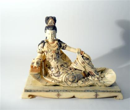 Appraisal: Chinese bone and polychrome Quanyin modelRecumbent on a lotus pod