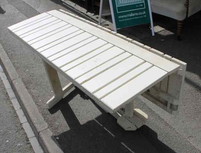 Appraisal: A WHITE PAINTED FOLDING GARDEN TABLE with supplementary flaps