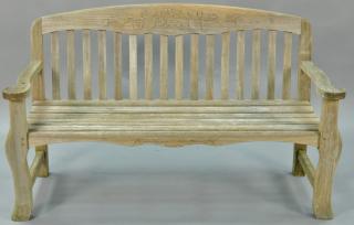 Appraisal: Teak bench with arms and flower carved back signed Kingsley-Bate