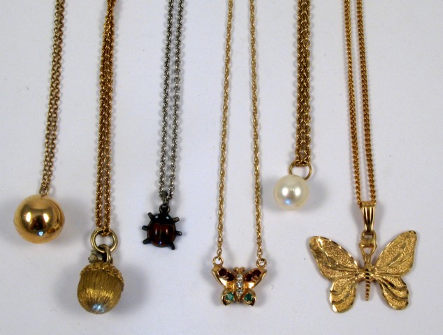 Appraisal: SIX PENDANT NECKLACES including a yellow gold ball pendant suspended