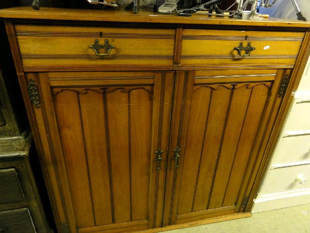 Appraisal: A late Victorian walnut side cupboard enclosed by a pair