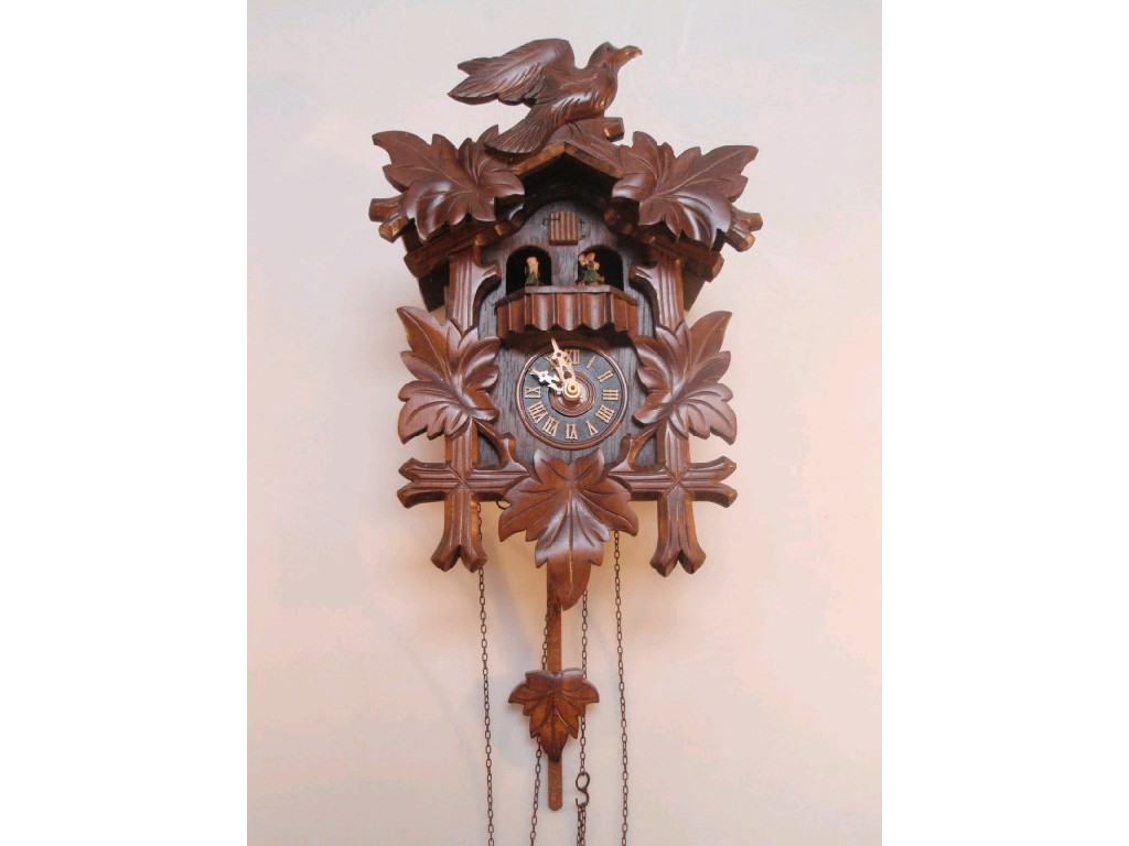 Appraisal: A Black Forest cuckoo clock with a Swiss musical movement