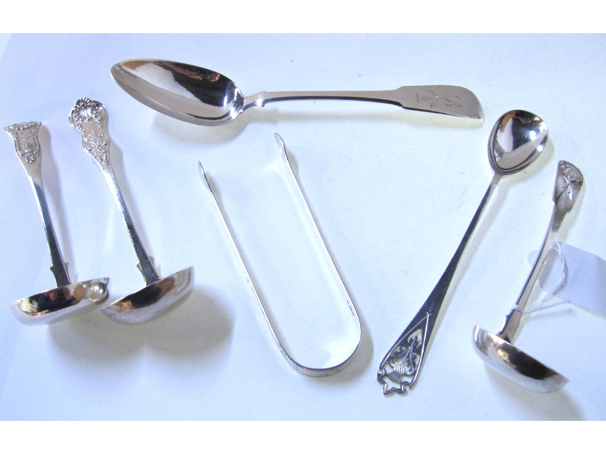 Appraisal: A lot comprising three silver sauce ladles a silver tablespoon