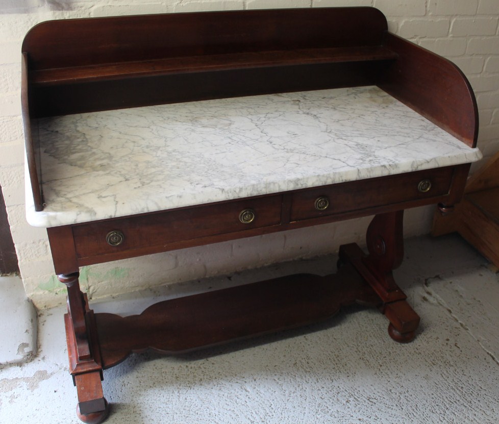 Appraisal: A Victorian mahogany marble top wash stand with a three