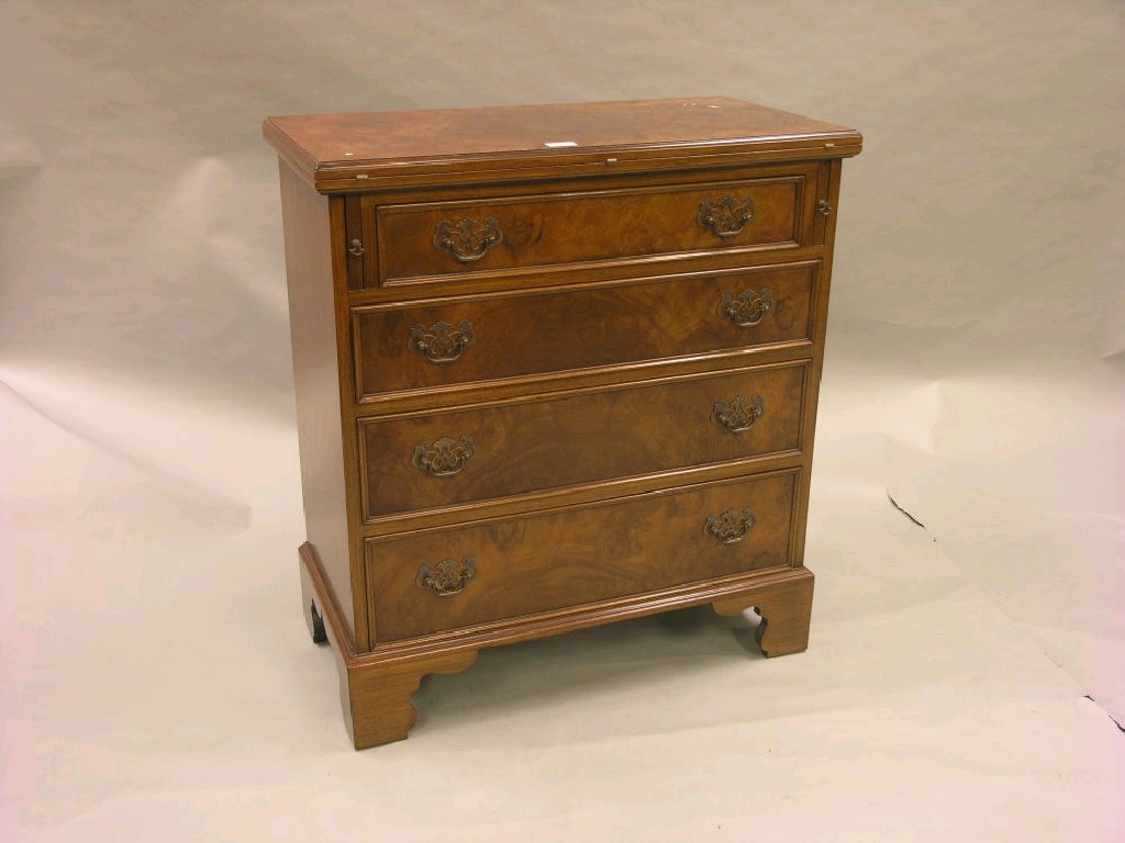 Appraisal: An early Georgian-style walnut bachelor's chest quarter-veneered top folding onto