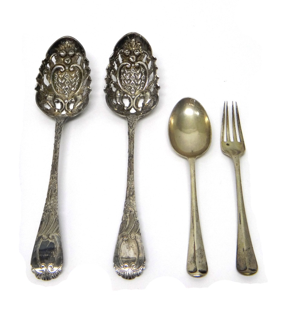 Appraisal: A pair of silver straining serving spoons with later embossed