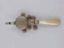 Appraisal: A yellow metal tests silver gilt baby rattle whistle probably