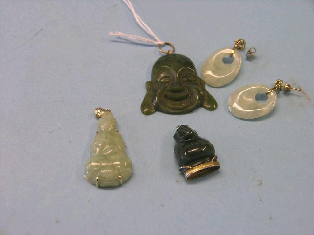 Appraisal: Three carved jade pendants and a pair of jade ear-rings