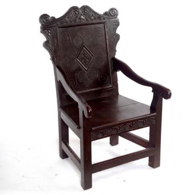 Appraisal: A carved oak panel back armchair incorporating th Century elements