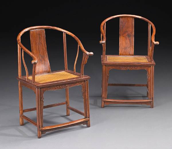 Appraisal: A good pair of huanghuali horseshoe back armchairs th Century