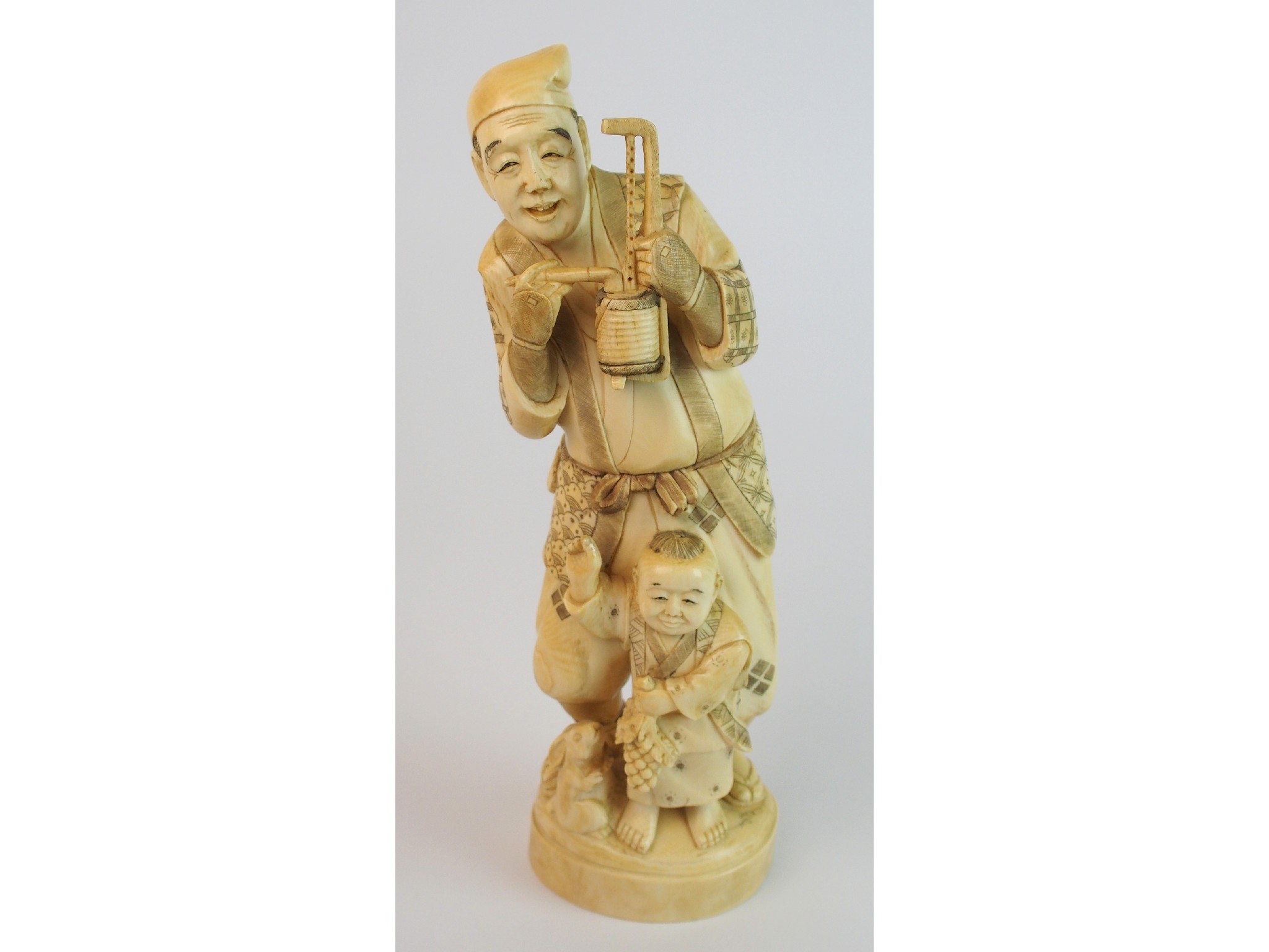 Appraisal: A Japanese ivory okimono of a father and sonthe man