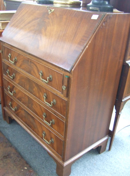 Appraisal: A George III style mahogany bureau the fall enclosing a