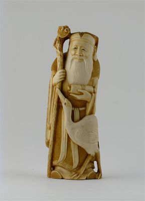 Appraisal: A Japanese ivory carving of Jurojin standing holding a scroll