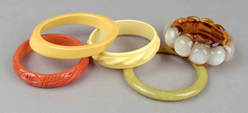 Appraisal: Four bakelite bangles to include orange yellow and marbleized green