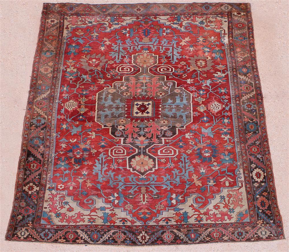 Appraisal: LARGE ANTIQUE PERSIAN SERAPI RUG with dramatic central medallion anchor