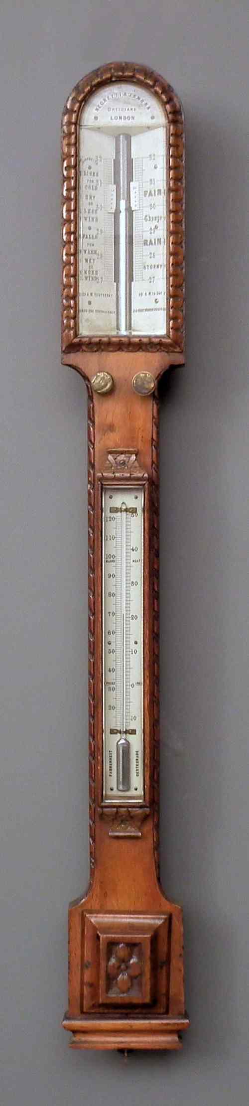 Appraisal: A Victorian oak cased stick barometer and thermometer by Negretti