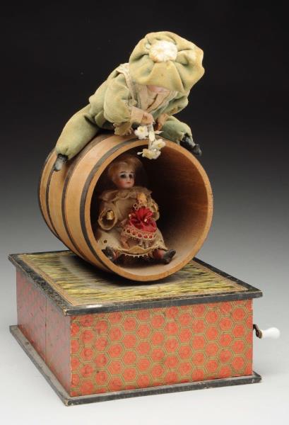 Appraisal: Musical Mechanical Toy Bisque headed boy on a barrel peeking