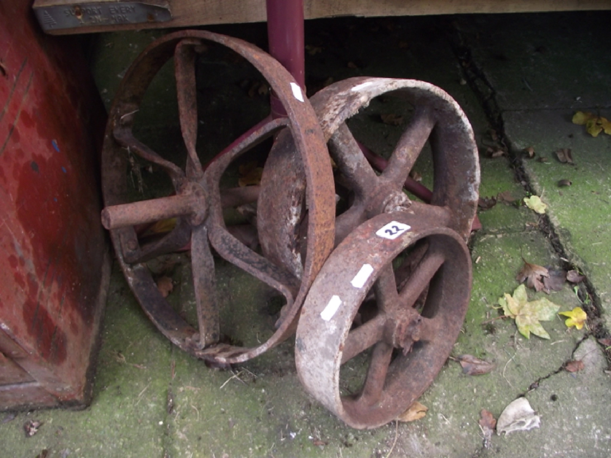 Appraisal: Three small vintage cast iron spoke wheels of varying size