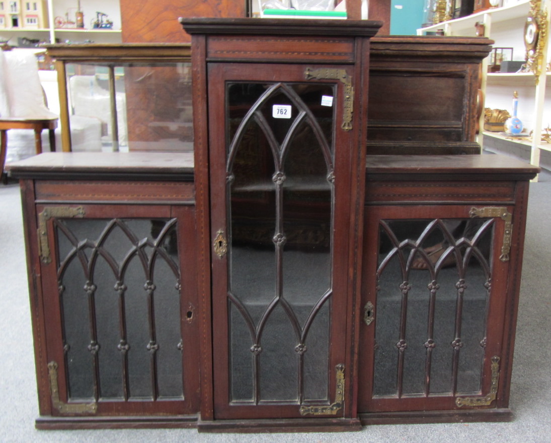 Appraisal: A Victorian inlaid mahogany Gothic Revival three door display cabinet