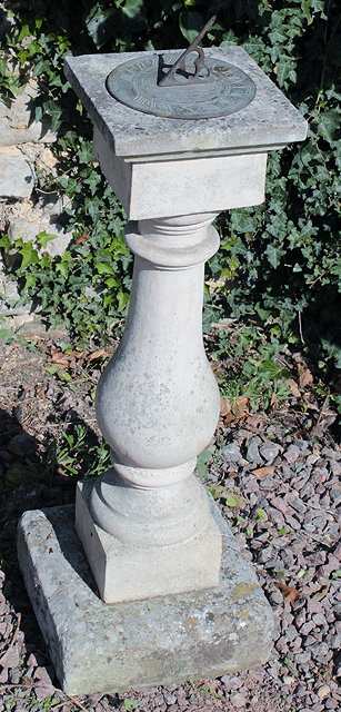 Appraisal: A WEATHERED COMPOSITION STONE GARDEN SUN DIAL with circular bronze