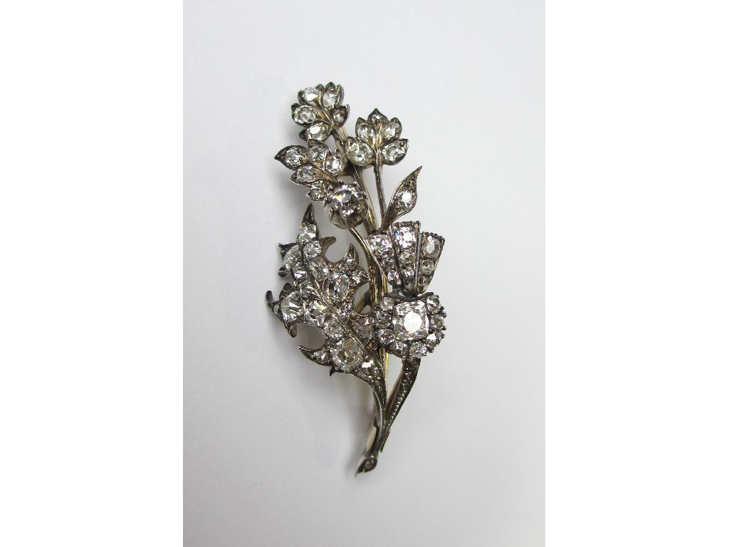 Appraisal: An Edwardian bi colour metal diamond thistle spray brooch with