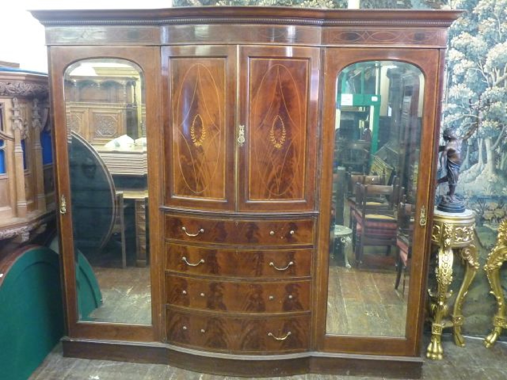 Appraisal: A substantial Edwardian triple wardrobe in the Sheraton manner the