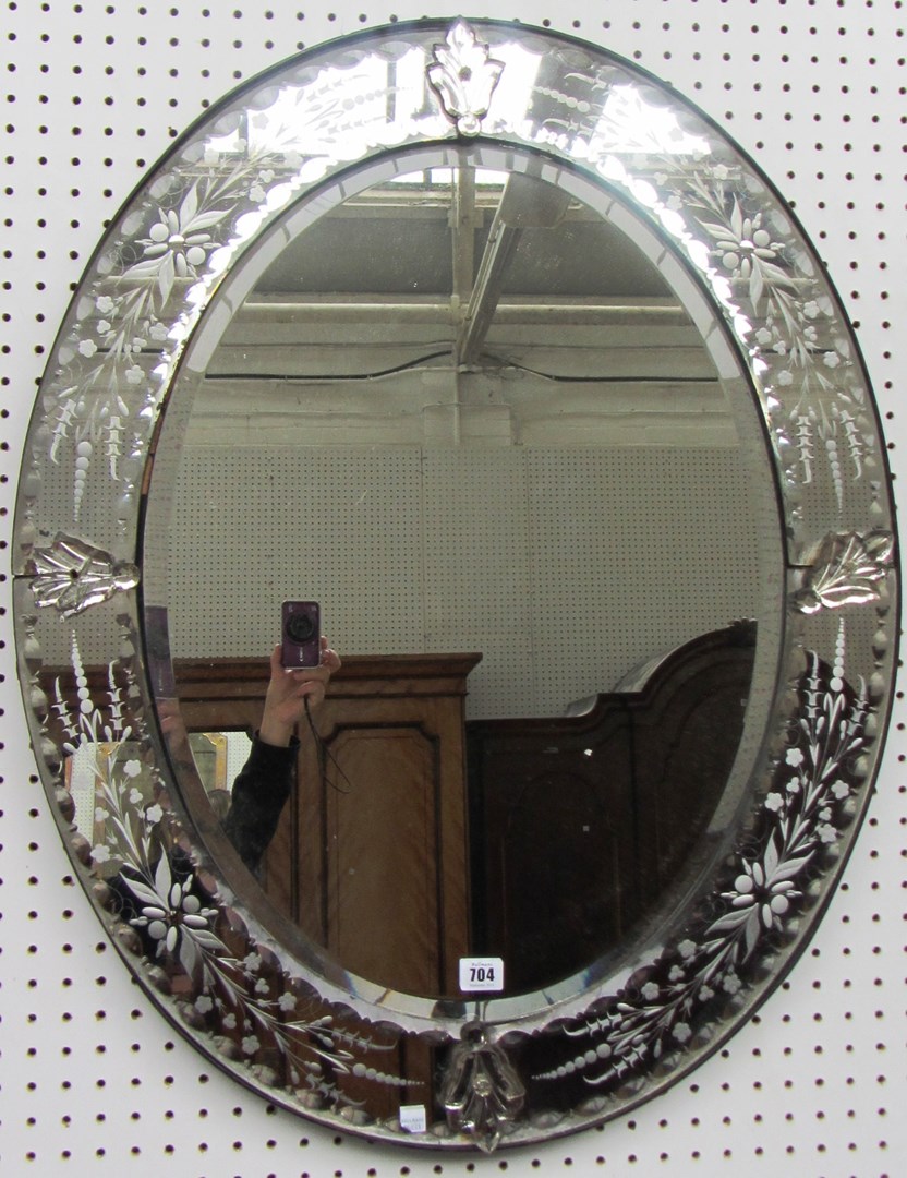 Appraisal: An Italian oval etched glass wall mirror cm x cm