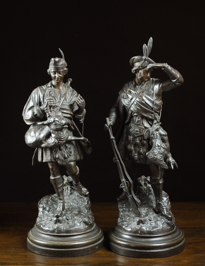 Appraisal: PAIR OF FIGURAL SPELTER SCULPTURES each depicting a male hunter