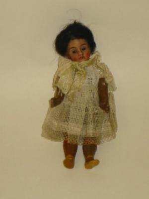 Appraisal: A Mulatto bisque head doll's house doll with fixed blue