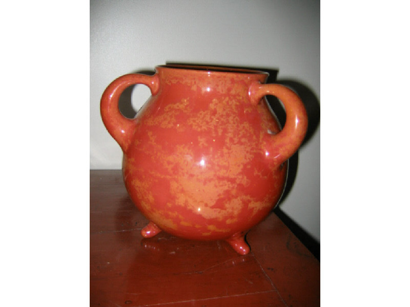 Appraisal: ZSOLNAY HUNGARY Orange glazed tri-footed pottery bowl with triple handle