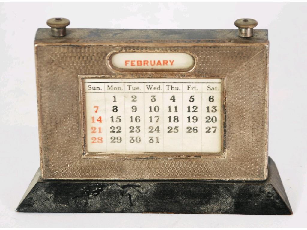 Appraisal: GEORGE V ENGINER TURNED SILVER MOUNTED EBONISED WOOD DESK CALENDAR