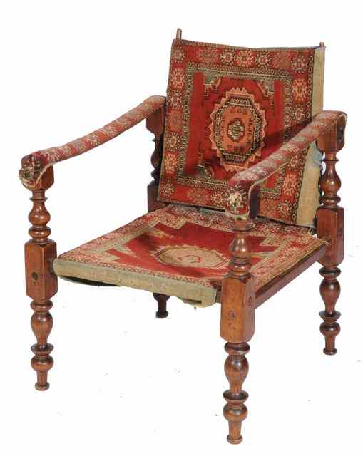 Appraisal: AN INDIAN HARDWOOD COLLAPSIBLE CAMPAIGN CHAIR with turned supports and