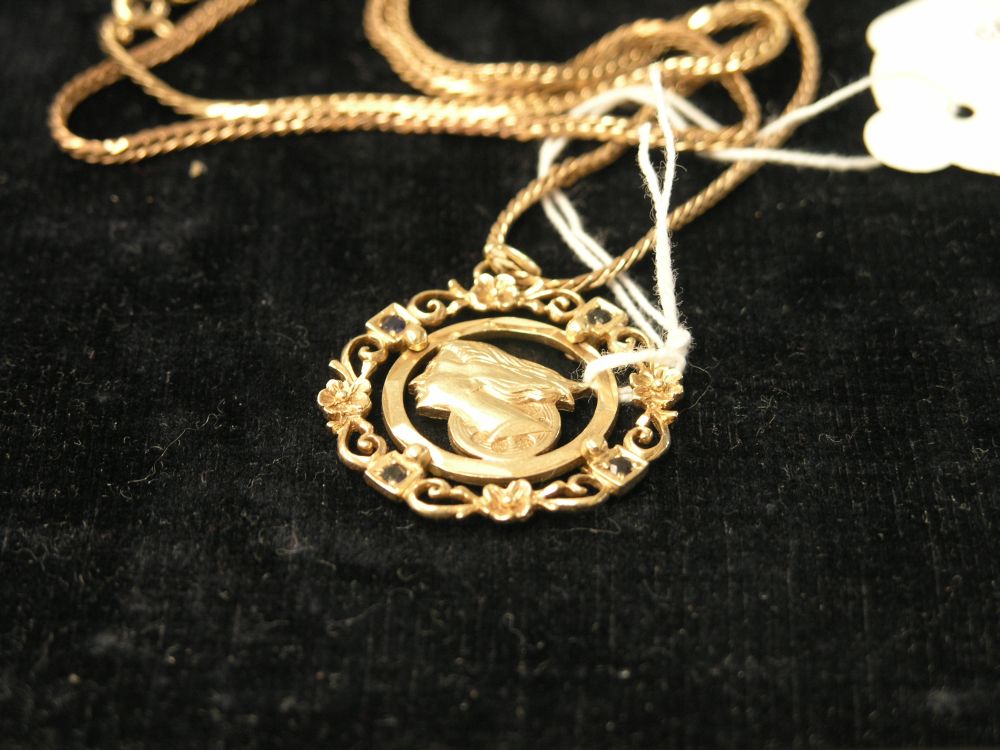 Appraisal: A ct gold pendant featuring female head on ct gold