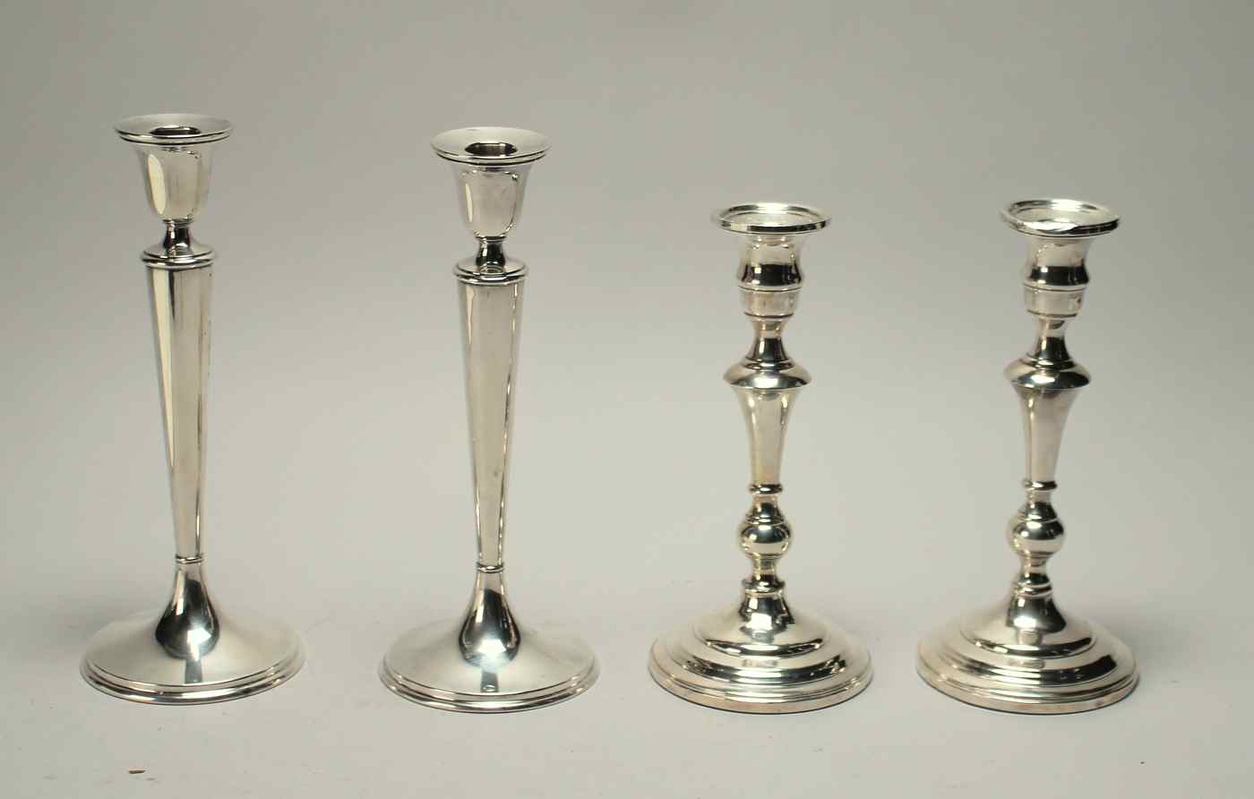 Appraisal: TWO PAIRS OF WEIGHTED STERLING SILVER CANDLESTICKSOne pair by Richard