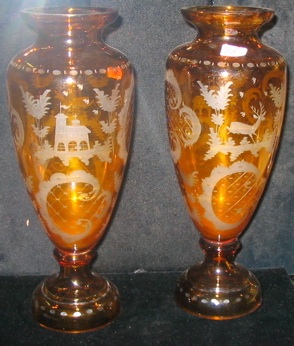 Appraisal: PAIR OF BOHEMIAN AMBER GLASS VASES having engraved designs of