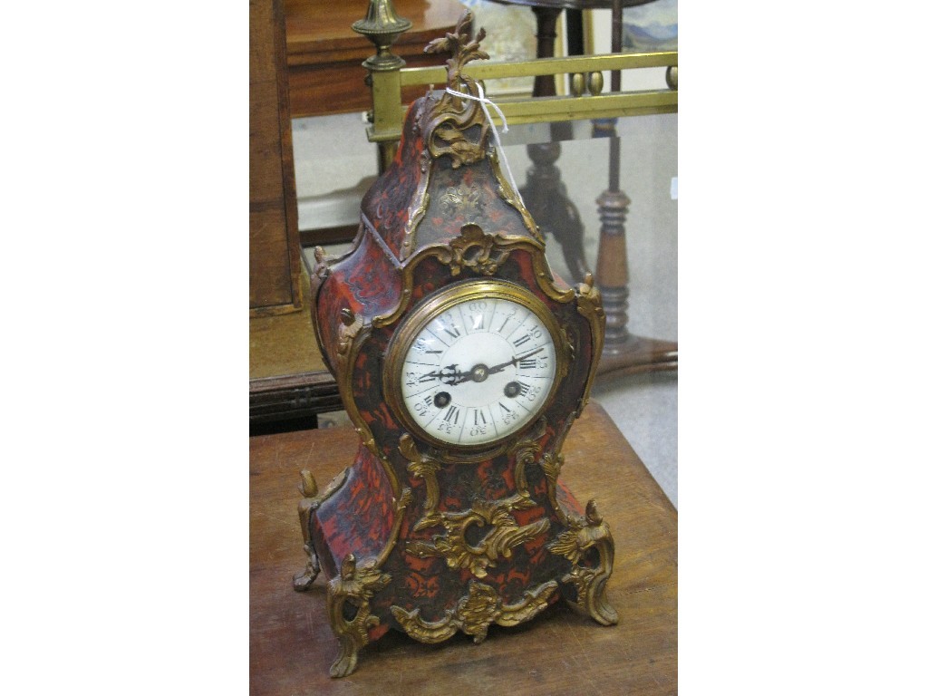 Appraisal: French red lacquered metal inlaid and ormolu mounted mantle clock