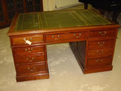 Appraisal: A MAHOGANY PARTNERS DESK the moulded edged top lined in