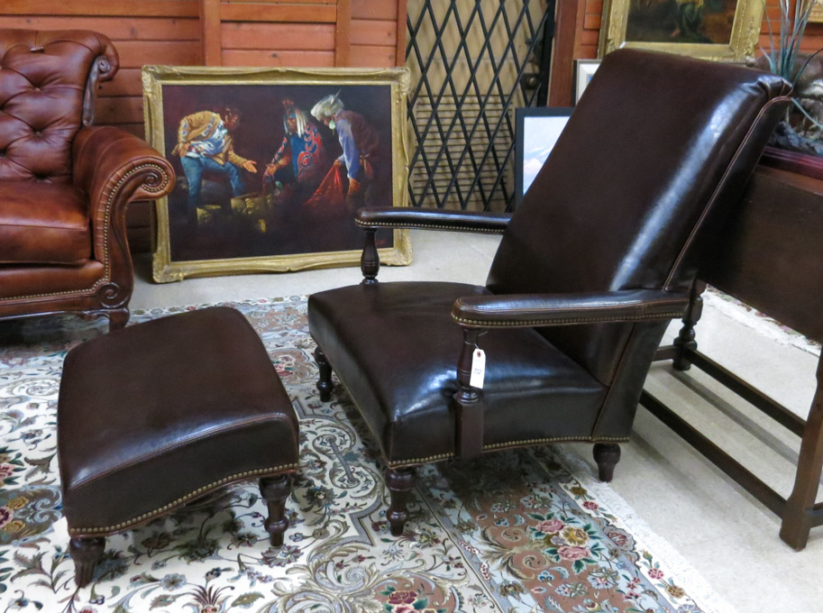 Appraisal: LEATHER AND MAHOGANY HIGH-BACK ARMCHAIR AND MATCHING OTTOMAN Bradington-Young Furniture