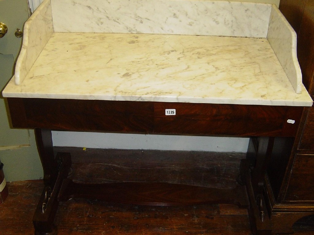 Appraisal: A Victorian mahogany wash stand the white marble top and