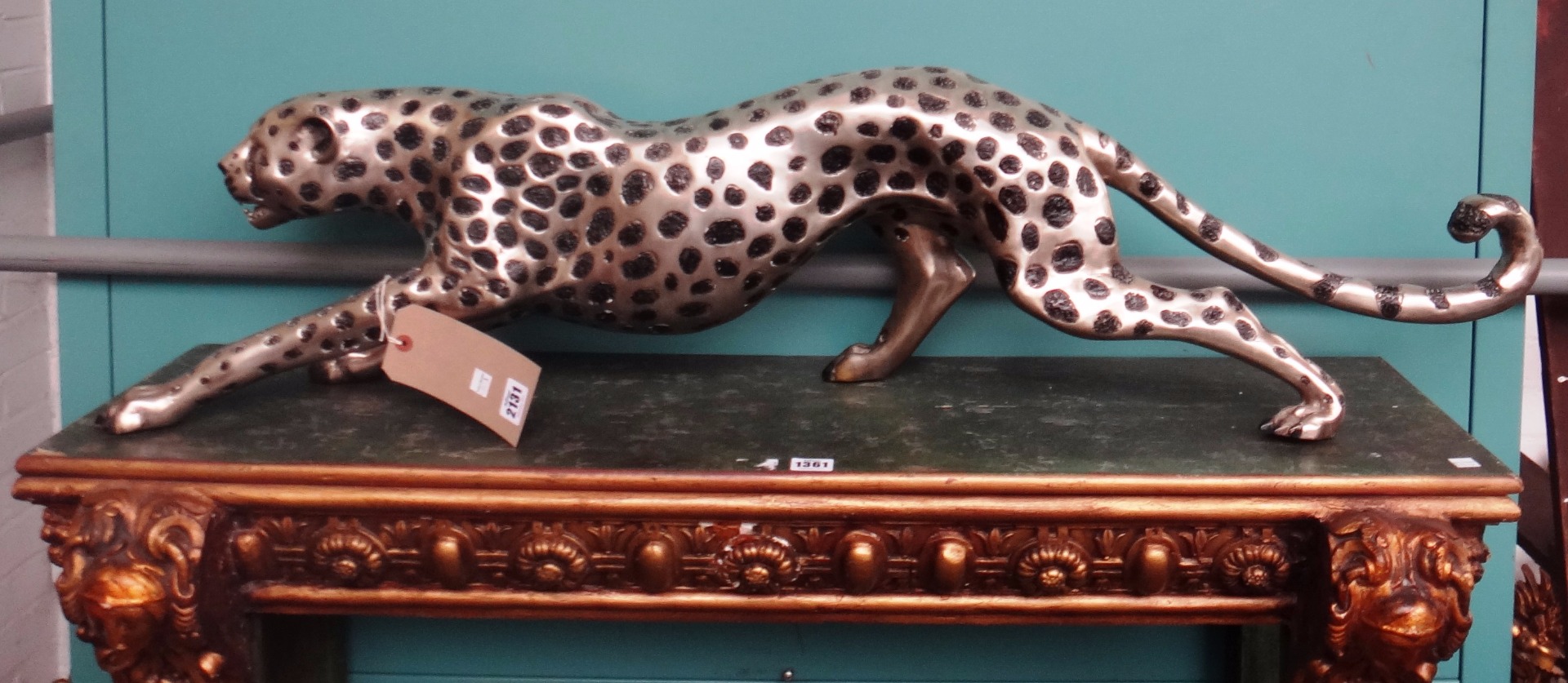 Appraisal: A silvered metal model of a jaguar in a prowling